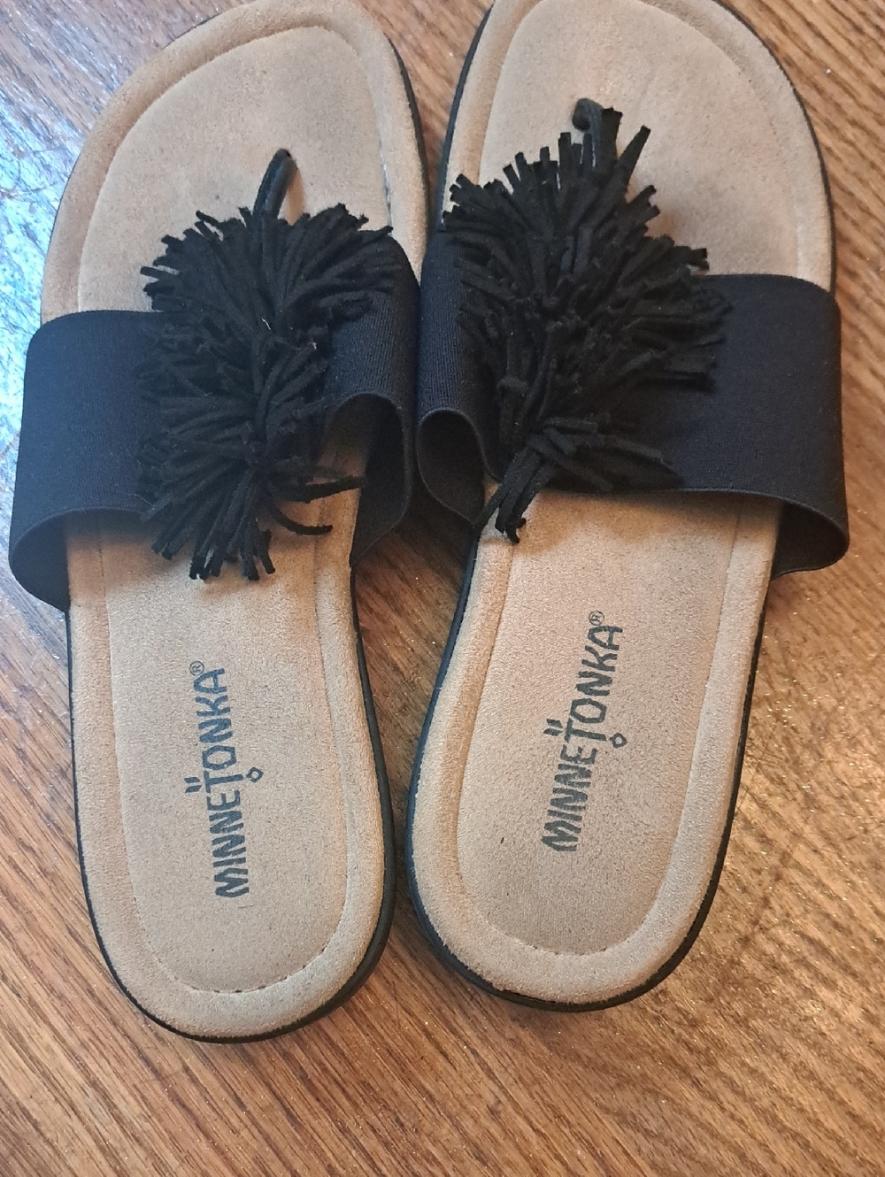 Minnetonka Black Slide Sandals with Fringe and Tan Footbed. Elastic Black Band